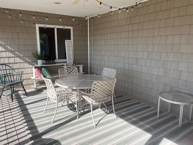 3199 S Lake Shore Dr, Bois Blanc, MI 49775 - wooden deck with a ceiling fan and outdoor dining space