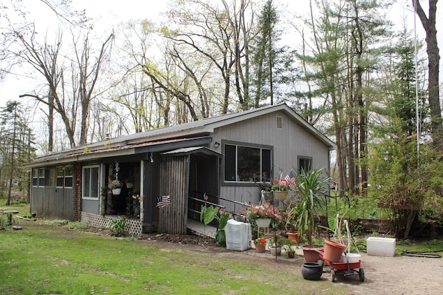 4541 Wills Rd, Lewiston, MI 49756 - view of side of property featuring a lawn