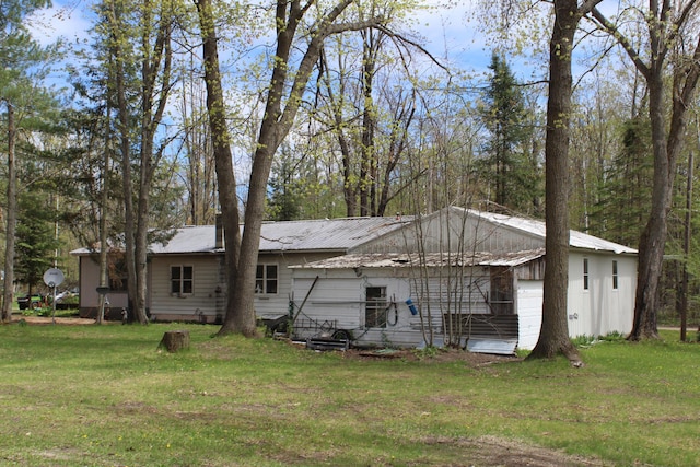 4541 Wills Rd, Lewiston, MI 49756 - back of property featuring a lawn and metal roof