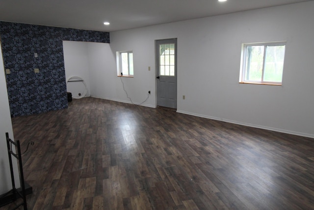 7844 Gilbert Trl, Grayling, MI 49738 - empty room with dark wood-style flooring, baseboards, recessed lighting, and an accent wall
