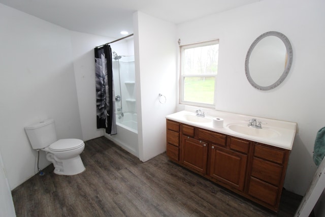 7844 Gilbert Trl, Grayling, MI 49738 - bathroom featuring wood finished floors, shower / bath combination with curtain, toilet, and double vanity