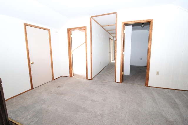 7844 Gilbert Trl, Grayling, MI 49738 - unfurnished bedroom with lofted ceiling and carpet floors