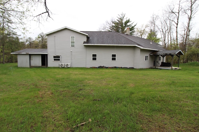 7844 Gilbert Trl, Grayling, MI 49738 - rear view of property with a lawn, a shingled roof, and a chimney