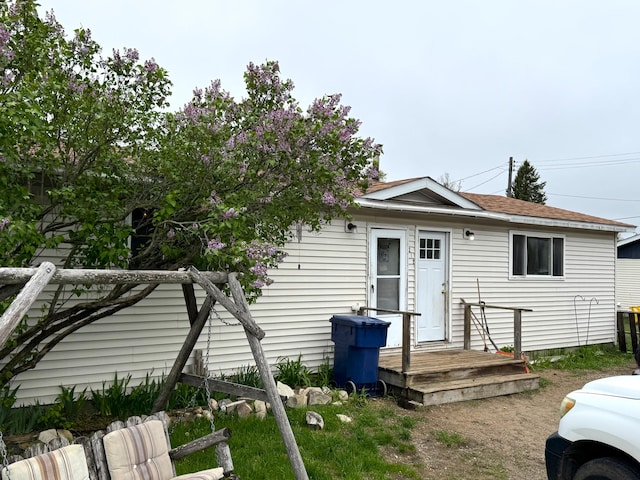 212 Scott St, Grayling, MI 49738 - back of house featuring roof with shingles