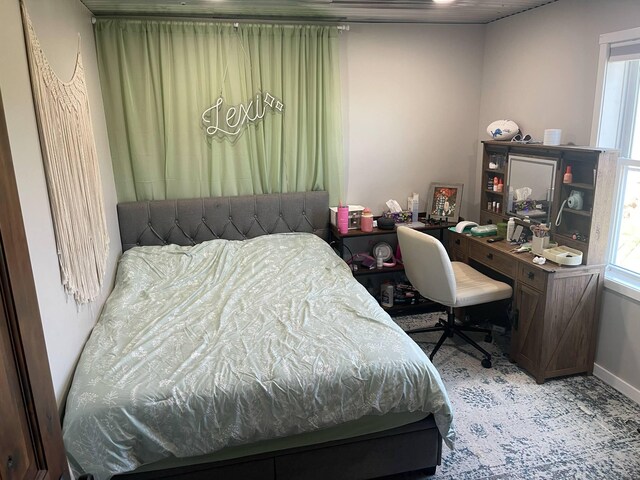 7557 Loop Rd, Posen, MI 49776 - carpeted bedroom with an office area and baseboards