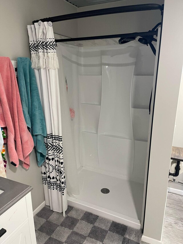 7557 Loop Rd, Posen, MI 49776 - full bathroom with a shower stall, vanity, and baseboards