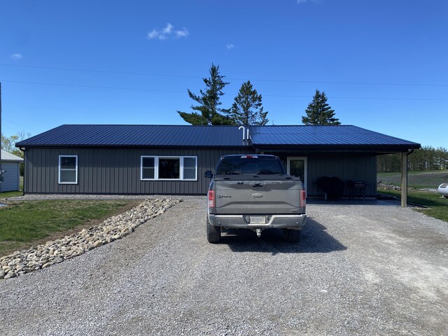 7557 Loop Rd, Posen, MI 49776 - ranch-style home with driveway and metal roof