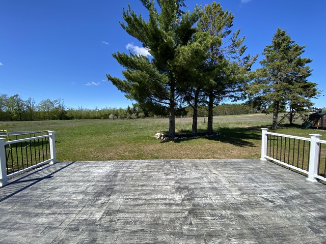 7557 Loop Rd, Posen, MI 49776 - deck with a yard