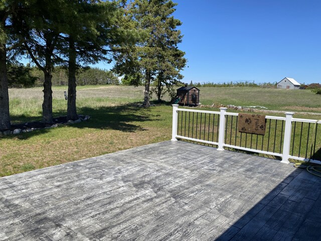 7557 Loop Rd, Posen, MI 49776 - wooden terrace featuring a yard, an outdoor structure, and a rural view