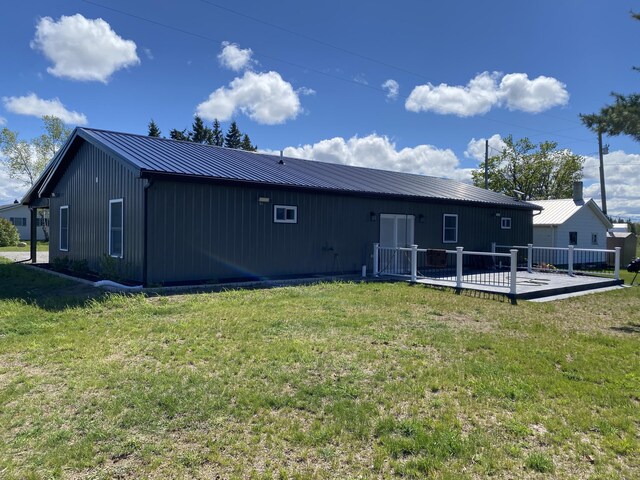 7557 Loop Rd, Posen, MI 49776 - back of property with a wooden deck, metal roof, and a yard