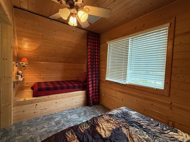 9841 Wheeler Rd, Roscommon, MI 48653 - unfurnished bedroom featuring wooden walls, wood ceiling, a sauna, and ceiling fan