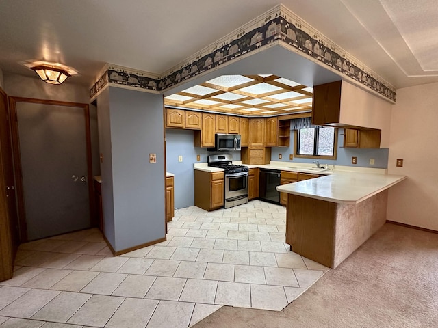 11030 S Stephan Bridge Rd, Roscommon, MI 48653 - kitchen with stainless steel appliances, a peninsula, a sink, brown cabinetry, and light countertops
