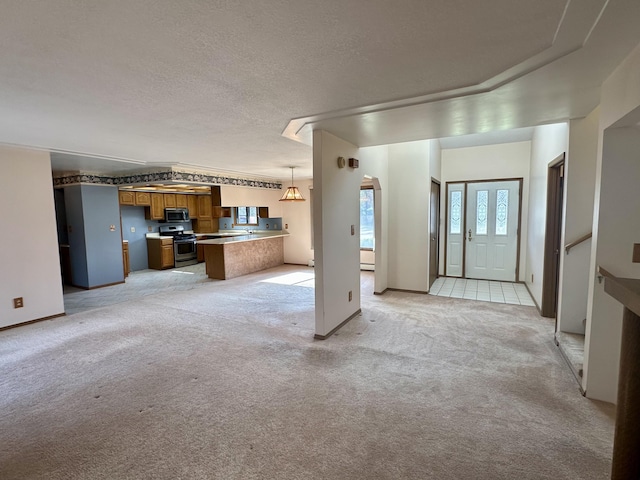 11030 S Stephan Bridge Rd, Roscommon, MI 48653 - unfurnished living room featuring healthy amount of natural light, light colored carpet, and a textured ceiling