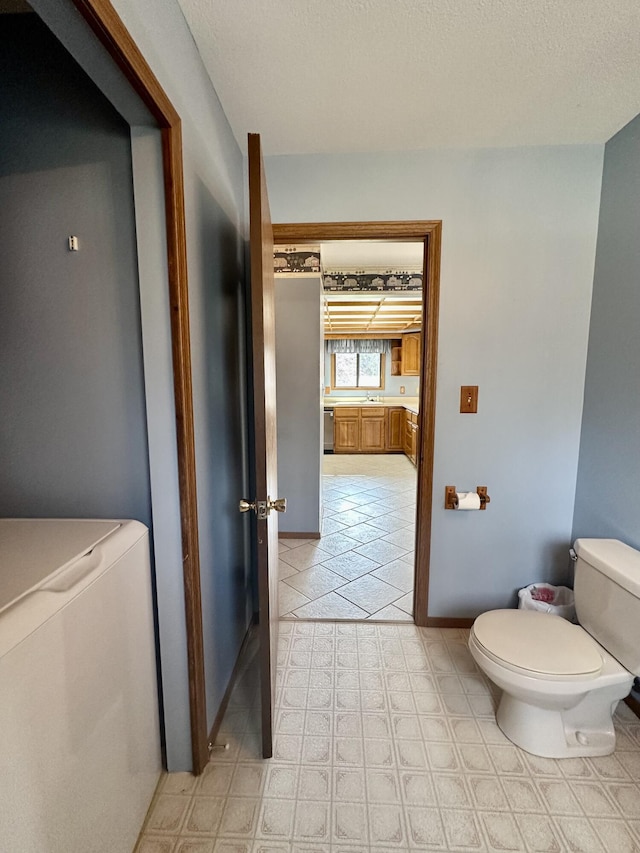 11030 S Stephan Bridge Rd, Roscommon, MI 48653 - half bath featuring toilet and a textured ceiling