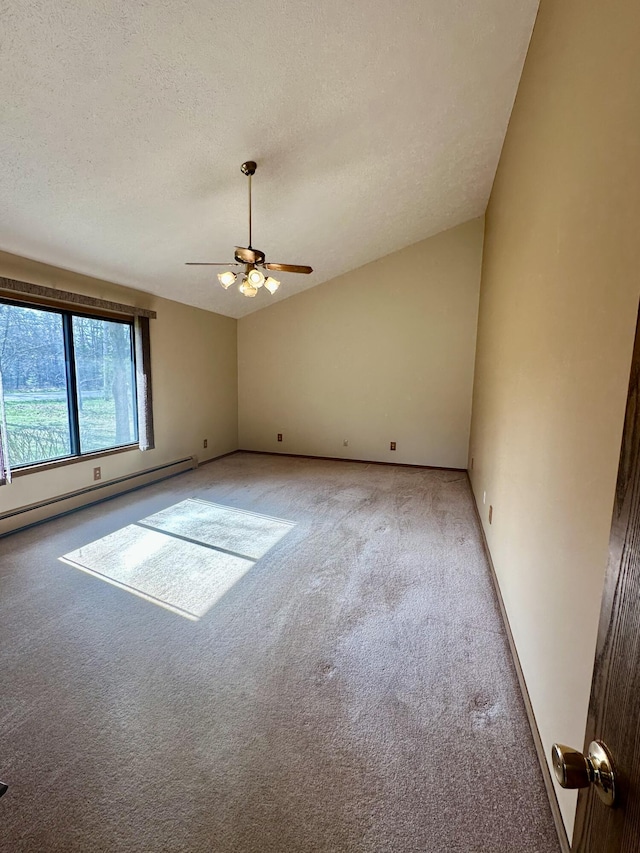 11030 S Stephan Bridge Rd, Roscommon, MI 48653 - spare room featuring light colored carpet, a baseboard radiator, ceiling fan, a textured ceiling, and vaulted ceiling