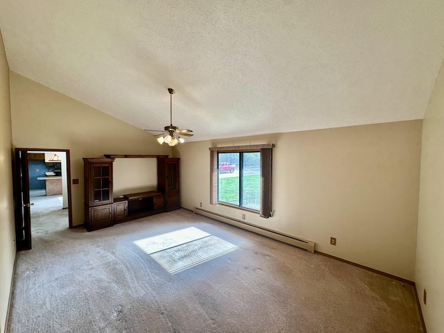 11030 S Stephan Bridge Rd, Roscommon, MI 48653 - unfurnished living room with a baseboard radiator, carpet floors, a ceiling fan, a textured ceiling, and vaulted ceiling