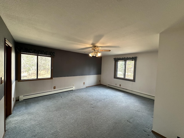 11030 S Stephan Bridge Rd, Roscommon, MI 48653 - empty room featuring baseboard heating, a ceiling fan, carpet flooring, and a textured ceiling