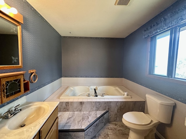 11030 S Stephan Bridge Rd, Roscommon, MI 48653 - full bath featuring a garden tub, toilet, vanity, and marble finish floors