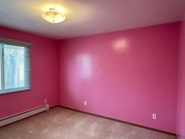 11030 S Stephan Bridge Rd, Roscommon, MI 48653 - spare room with a baseboard radiator, carpet, a textured ceiling, and baseboards