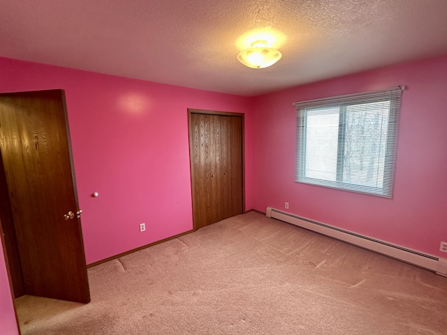 11030 S Stephan Bridge Rd, Roscommon, MI 48653 - unfurnished bedroom featuring carpet, a closet, a baseboard radiator, and a textured ceiling