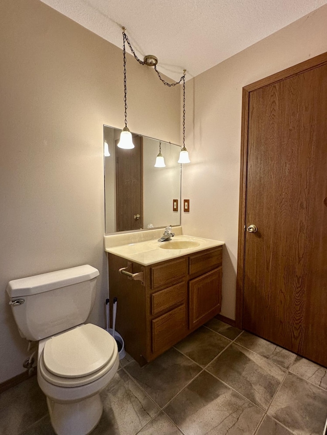 11030 S Stephan Bridge Rd, Roscommon, MI 48653 - bathroom featuring vanity, toilet, a textured ceiling, baseboards, and tile patterned floors