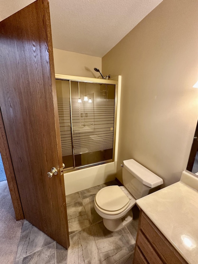 11030 S Stephan Bridge Rd, Roscommon, MI 48653 - full bath featuring enclosed tub / shower combo, vanity, a textured ceiling, and toilet