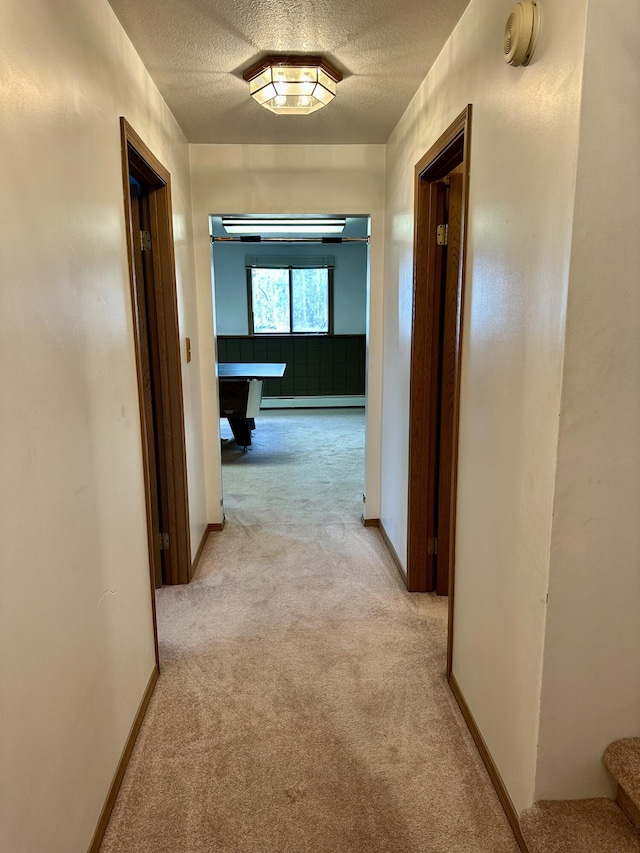 11030 S Stephan Bridge Rd, Roscommon, MI 48653 - corridor featuring light carpet, a textured ceiling, baseboards, and stairs