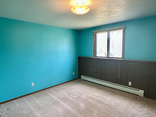 11030 S Stephan Bridge Rd, Roscommon, MI 48653 - spare room with a baseboard heating unit, carpet flooring, and a textured ceiling