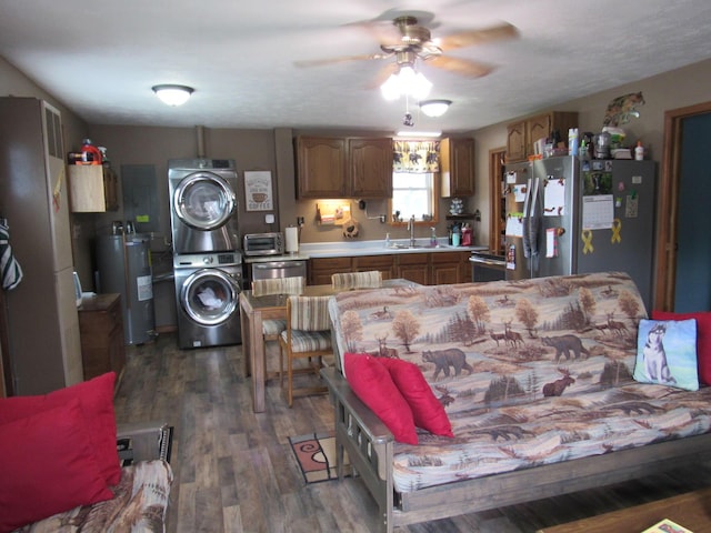 2020 Douglas Dr, Saint Helen, MI 48656 - kitchen with stacked washer and clothes dryer, electric water heater, appliances with stainless steel finishes, a sink, and light countertops
