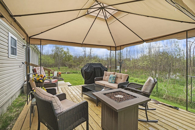 398 Vale St, Cheboygan, MI 49721 - wooden deck featuring grilling area and an outdoor living space with a fire pit