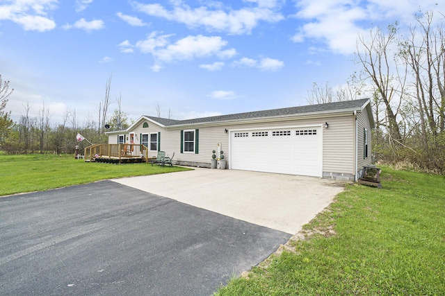 398 Vale St, Cheboygan, MI 49721 - view of front of home with a garage, driveway, a wooden deck, and a front yard