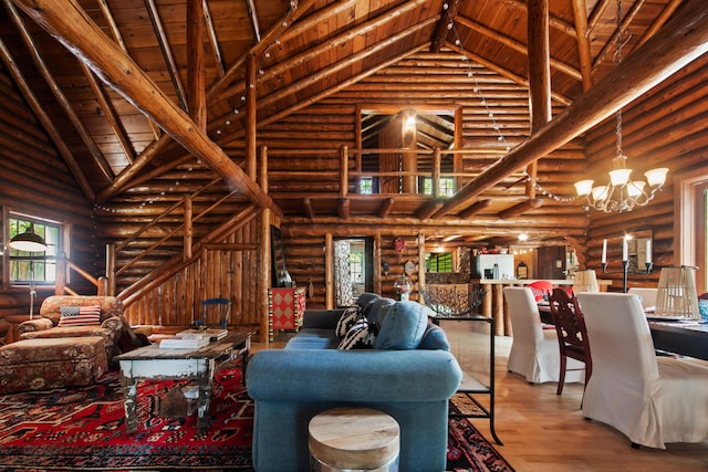 4423 Island View Dr, Gaylord, MI 49735 - living room featuring log walls, high vaulted ceiling, wood finished floors, a chandelier, and wooden ceiling