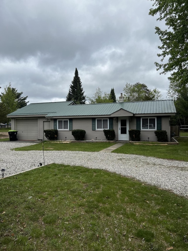 1828 Higgins, Saint Helen, MI 48656 - ranch-style house featuring driveway, an attached garage, a chimney, metal roof, and a front yard
