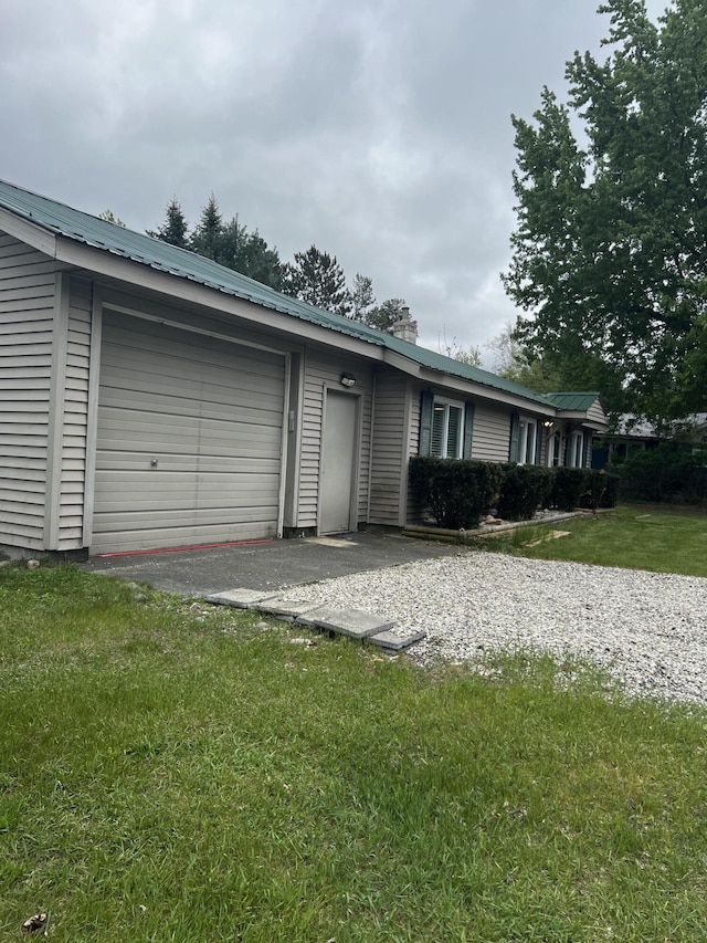 1828 Higgins, Saint Helen, MI 48656 - ranch-style house featuring metal roof, a garage, driveway, and a front yard