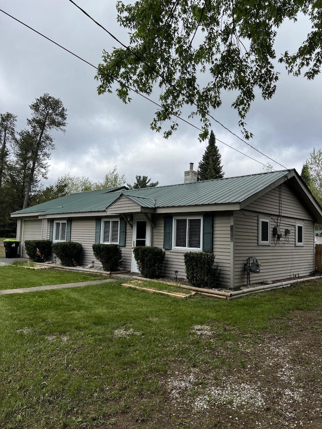 1828 Higgins, Saint Helen, MI 48656 - single story home featuring an attached garage, a chimney, metal roof, and a front lawn