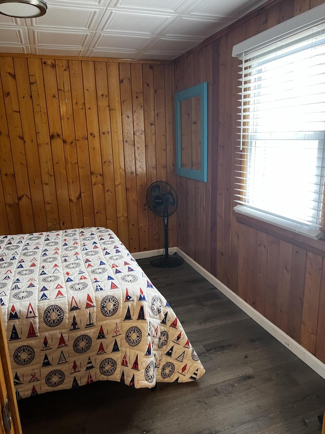 1828 Higgins, Saint Helen, MI 48656 - bedroom featuring baseboards, wood walls, dark wood-style floors, and an ornate ceiling