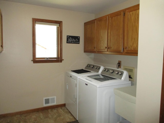 5622 Vacationland Dr, Lewiston, MI 49756 - washroom featuring washing machine and dryer, cabinet space, and baseboards