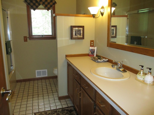 5622 Vacationland Dr, Lewiston, MI 49756 - full bathroom featuring toilet, vanity, an enclosed shower, and baseboards