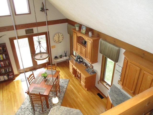 5622 Vacationland Dr, Lewiston, MI 49756 - dining area featuring light wood-style flooring, baseboards, and lofted ceiling