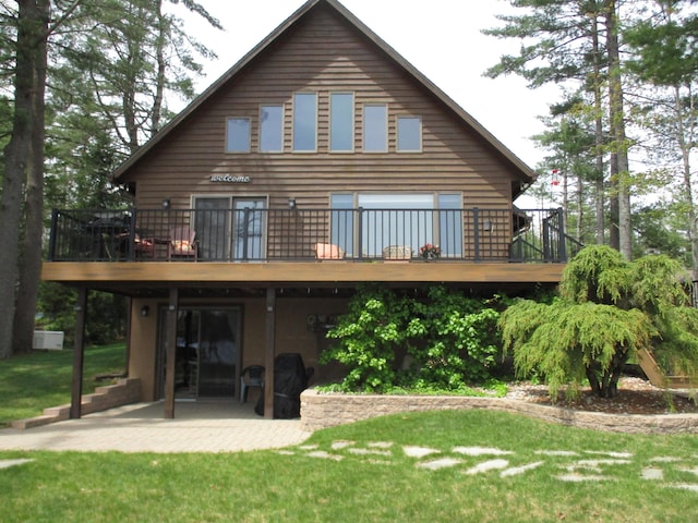 5622 Vacationland Dr, Lewiston, MI 49756 - back of house featuring a patio area, a deck, and a yard