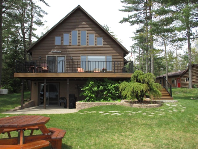 5622 Vacationland Dr, Lewiston, MI 49756 - rear view of house featuring a patio, a deck, a lawn, and stairs
