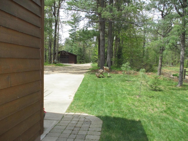 5622 Vacationland Dr, Lewiston, MI 49756 - view of green lawn featuring an outdoor structure and driveway