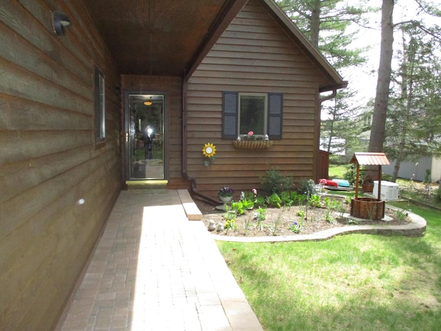5622 Vacationland Dr, Lewiston, MI 49756 - view of exterior entry with a yard