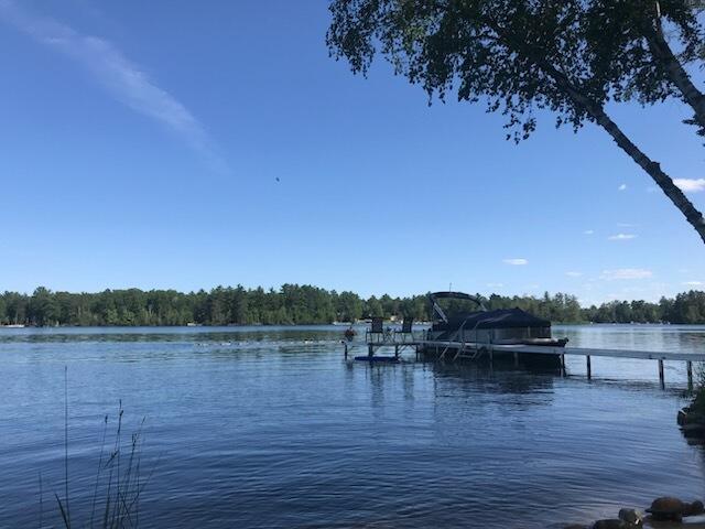 5622 Vacationland Dr, Lewiston, MI 49756 - dock with a water view and a wooded view