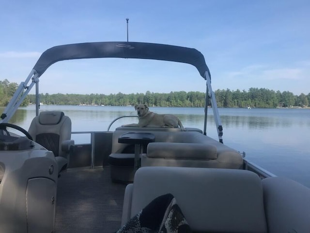 5622 Vacationland Dr, Lewiston, MI 49756 - dock area featuring a wooded view and a water view