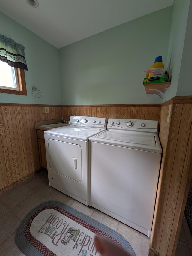 6783 E Houghton Lake Dr, Houghton Lake, MI 48629 - washroom with washer and clothes dryer, wainscoting, cabinet space, and light tile patterned flooring