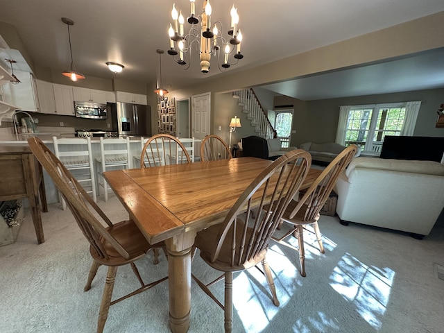 240 Monroe Blvd, Roscommon, MI 48653 - dining area featuring a chandelier, stairway, and light colored carpet