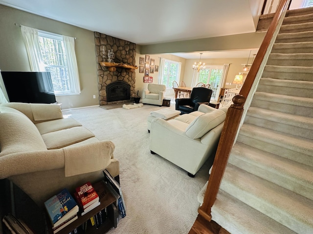240 Monroe Blvd, Roscommon, MI 48653 - living area featuring stairs, a chandelier, a stone fireplace, and baseboards