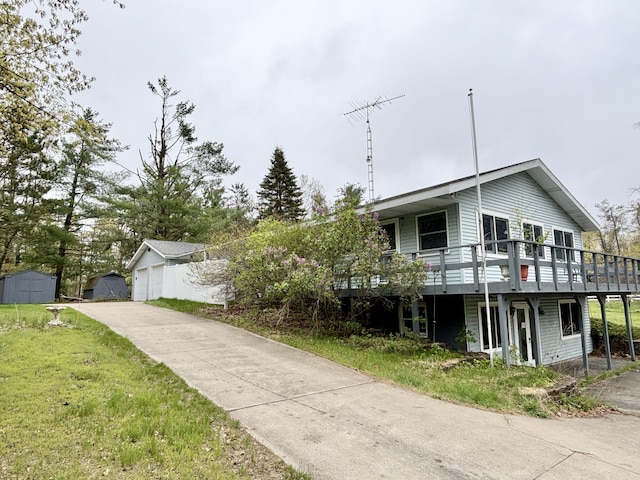5356 Spruce Dr, Lewiston, MI 49756 - view of front facade with a wooden deck and a garage