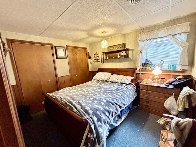 5356 Spruce Dr, Lewiston, MI 49756 - bedroom featuring a paneled ceiling and wood walls